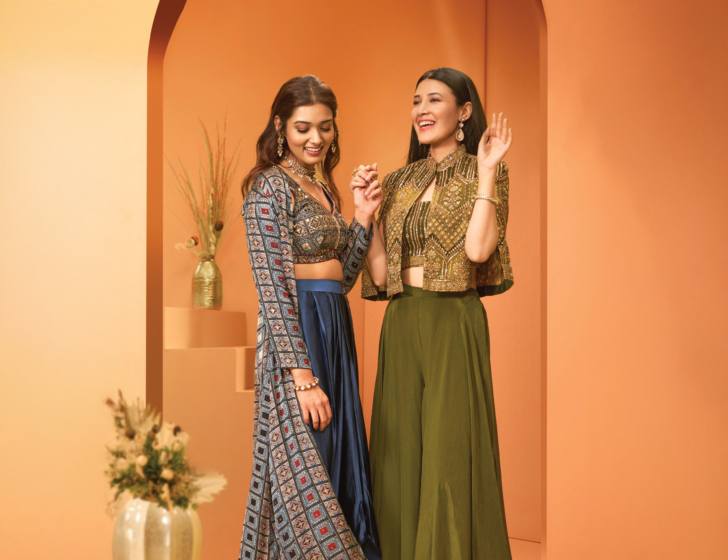 Left: blue patterned indo-western set; right: bottle-green and gold indo-western set